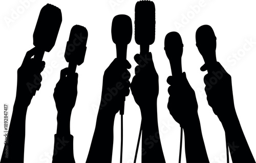 Microphones held up by reporters at press conference silhouette