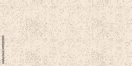 Close up of a textured beige surface with a speckled grainy pattern