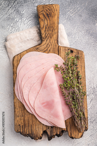 Obraz na plátně Delicious slices of cured ham on a wooden platter, ideal for entertaining and adding flavor to your dishes