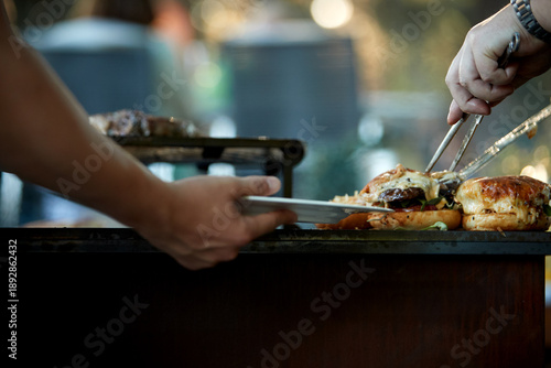 Catering staff serving prepared meals from a buffet line during a professional event, ideal for: corporate catering, hospitality services, food service operations, business events.
