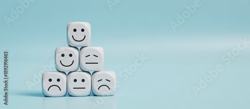 world mental health day concept or feedback rating and positive customer review, wood cube stacking with emotion face icon on blue background 
