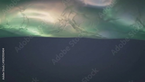 Mystical Northern Lights: An enchanting display of vibrant green and ethereal colours dances across the night sky, creating a spellbinding spectacle. The scene evokes a sense of wonder and awe.