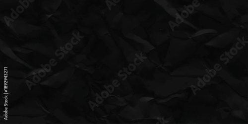 crumpled paper background. Black crumpled paper texture with folds, black background.