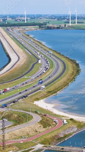 cluster dark modern visitor buildings integrated into landscape historic grassy bunkers winding footpaths sit major highway afsluitdijk netherlands near architecture 
