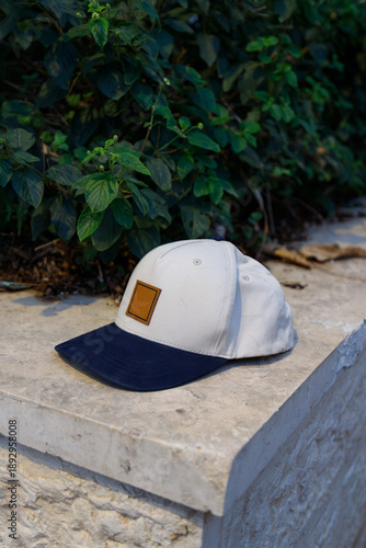 Casual baseball cap placed on a stone surface outdoors. Everyday fashion, urban leisure