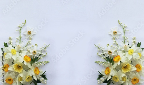 A bouquet of daffodils on a white background with space for text