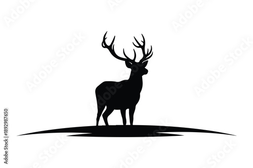 Majestic stag with antlers silhouetted on a hill, black and white