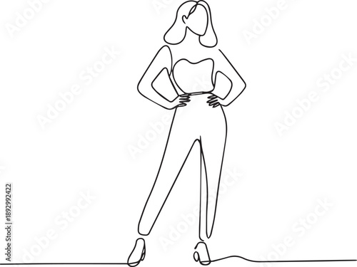A confident woman posing in a stylish outfit standing alone