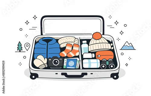Winter Suitcase Essentials. Winter travel packing concept. Open suitcase with warm clothes, hat, socks, and travel accessories carefully placed inside, showing
