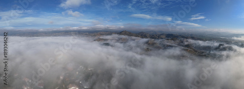Schilderij op canvas Panoramic aerial view above clouds over Andalusian countryside near Malaga