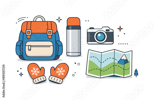 Winter Travel Essentials. Winter vacation travel items. Backpack, thermos, camera, mittens, and folded map arranged as a tidy flat lay, expressing readiness