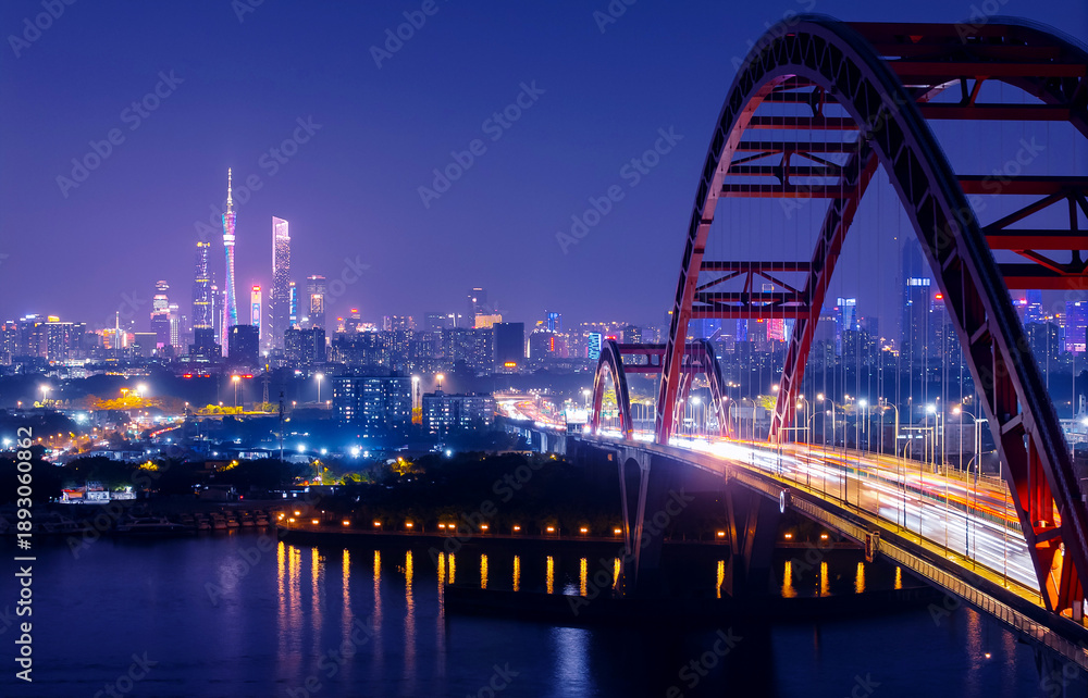 Obraz premium Aerial night view of Guangzhou cityscape with illuminated red bridge and skyline. Travel photo of Guangdong China