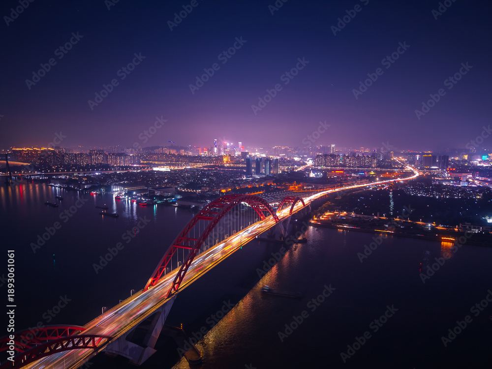 Obraz premium Aerial nightscape of Guangzhou, illuminated skyline and bridges with traffic jam of car