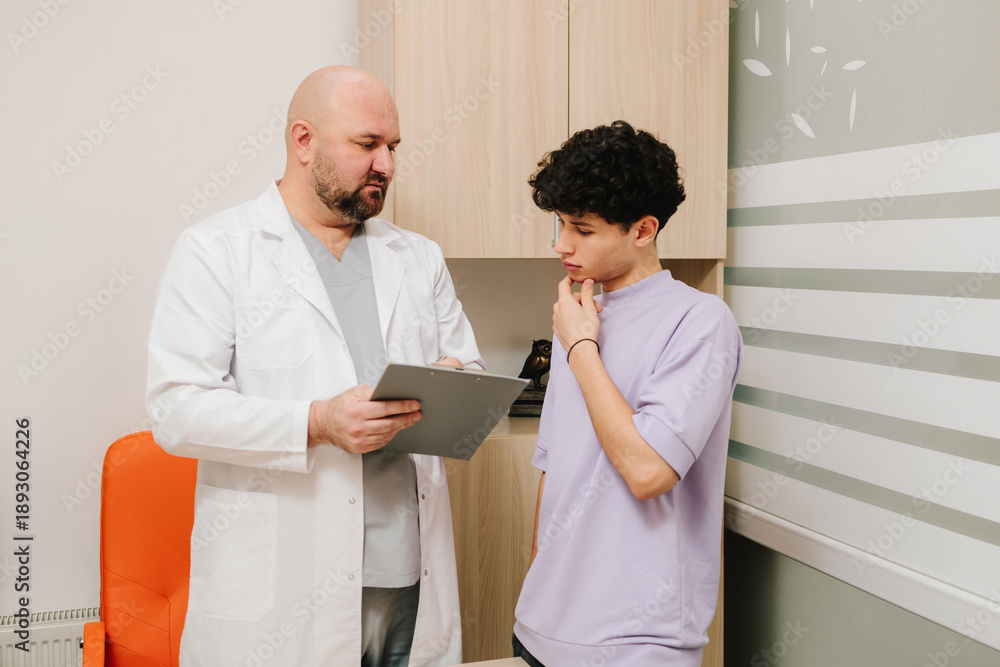 Fototapeta premium Patient discussing urinary tract health with urologist during exam.
