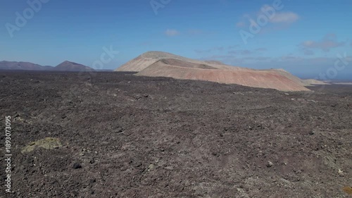 Aerial view of Caldera de Montana Blanca volcanic crater near Timanfaya National Park, Lanzarote, Canary islands, Spain.