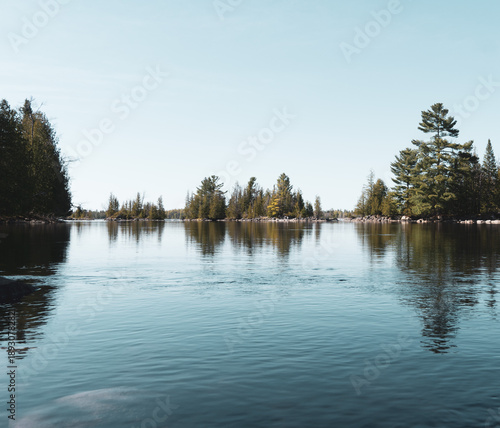 Calm water and shoreline on the Ottawa River, Canada