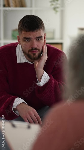 Stressed young man talking to therapist during a psychology session