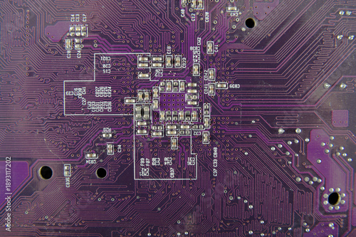 Detailed purple printed circuit board with electronic traces and SMD components, high tech electronics background