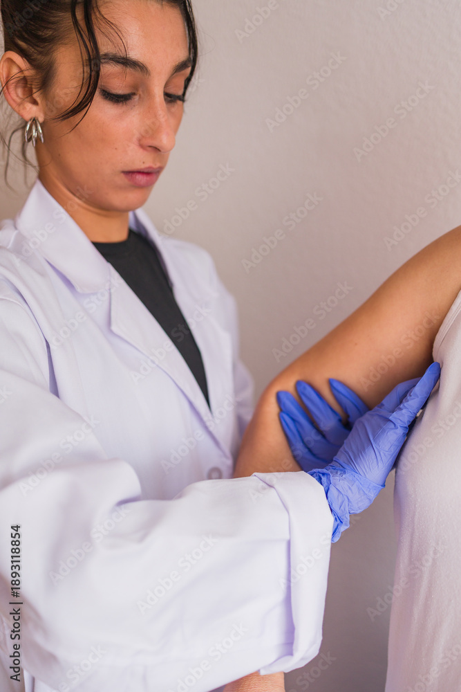 Naklejka premium Doctor performing breast examination for cancer detection