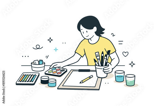 Art Session Setup. Setting up an art session. Person arranging paints, pencils, brushes, and paper on a table, preparing for a drawing or painting activity.