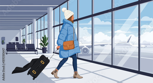 Traveler with luggage in modern airport terminal.
