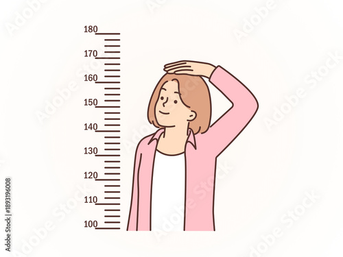 Εκτύπωση καμβά Smiling Young Woman Measuring her Height Against the Wall Scale