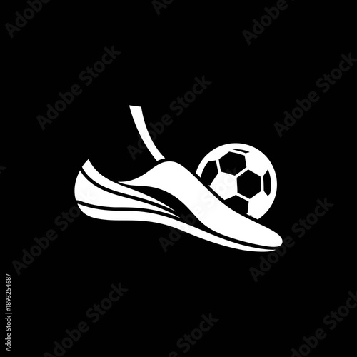 White soccer shoe kicking a soccer ball on black background.