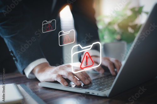 Schilderij op canvas Business person typing on laptop with red warning folder icons