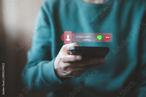 Close up of a hand holding a smartphone with an unknown incoming call hologram. Concept of scammer, telemarketing, and digital privacy protection. Perfect for cybersecurity and mobile technology.