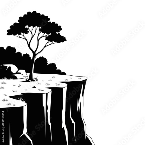 Silhouette of a lone tree on a cliff edge with rocky outcrop and sparse grass