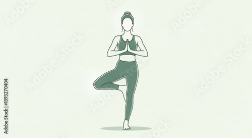Woman in yoga tree pose with hands together in front of her chest on a light green background