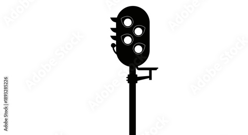 Silhouette of an old railway signal light post.