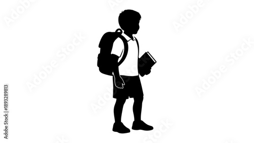 Silhouette of a young boy with a backpack and book.