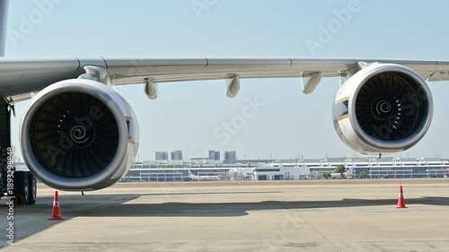4K Large two turbofan engines rotating on a quadjet airplane wing