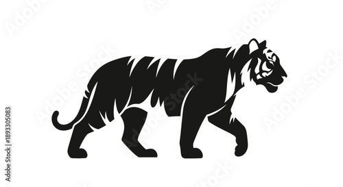 Silhouette of a majestic tiger walking with its tail held high.