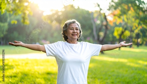 Wallpaper Mural Happy Mature Woman in White Top Spreading Arms Wide in a Green Park Under Bright Sunlight Torontodigital.ca