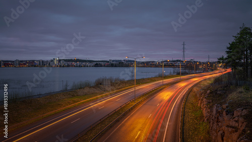 Tableau sur toile Evening light softens the highway beside Jyväskylä’s calm beach.
