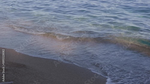 Wallpaper Mural Close view of clear sea water gently washing over sandy shoreline in daylight, symbolizing calmness, nature, summer travel and coastal serenity. Torontodigital.ca