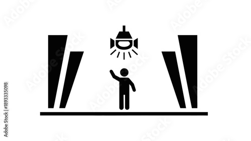 Person standing under spotlight on stage with pillars.