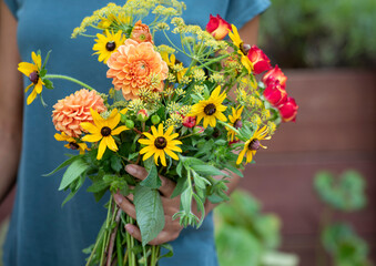 Woman holding fresh cut garden flowers