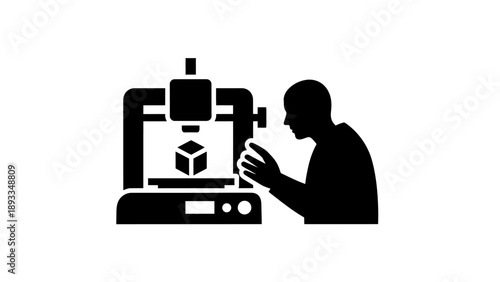 Person operating a 3D printer creating a cube object.