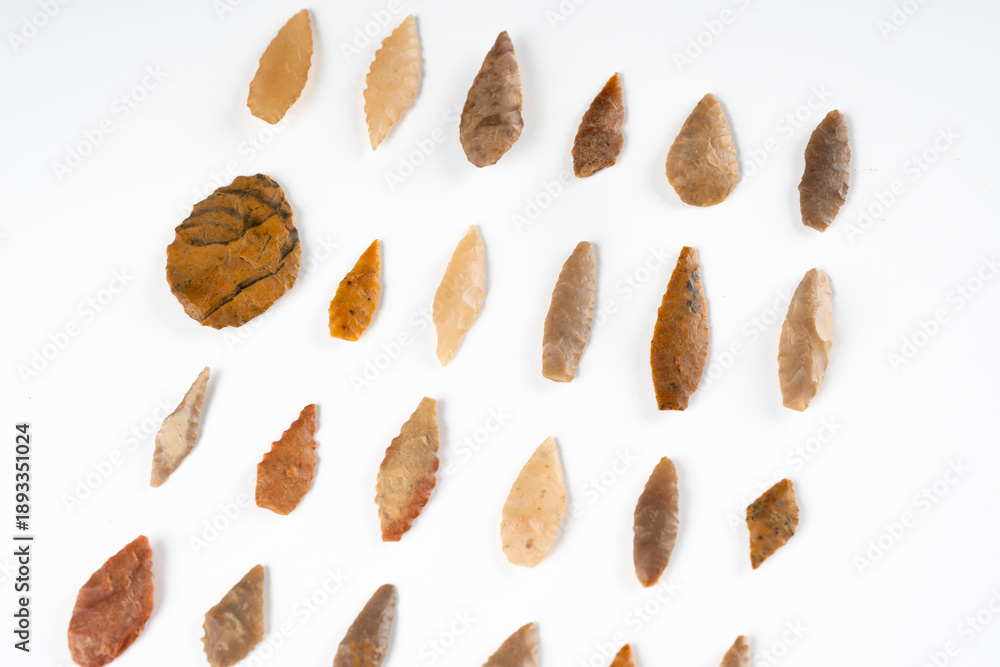 Obraz premium Collection of Rare Paleolithic Bifacial Stone Arrowheads from Algerian Sahara Desert on White Background