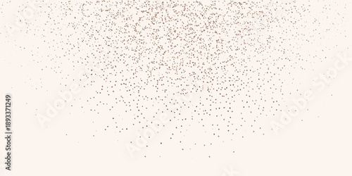 Delicate scattering of golden glitter particles on a light background