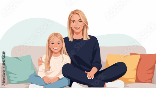 A woman and a girl with blonde hair sit on a couch, smiling at the camera