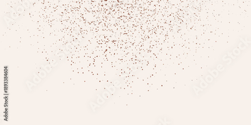 Delicate scattering of reddish brown particles over a light beige background