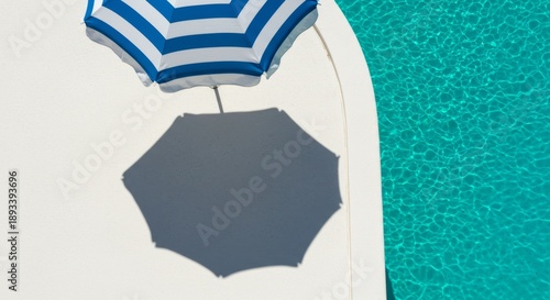 Blue And White Striped Beach Umbrella Beside Teal Pool