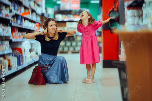 Canvas Print Mom Covers Her Ears When Her Child Screams in the Supermarket