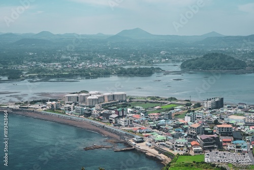 Overhead aerial view of the beach and isthmus, as seen from above on the Seongsan Ilchulbong volcano, also called Sunrise Peak, in Seogwipo, Jeju Island, South Korea