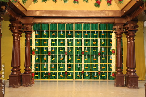 Indian stage decoration with multi color flowers, props and lights. wedding stage decoration