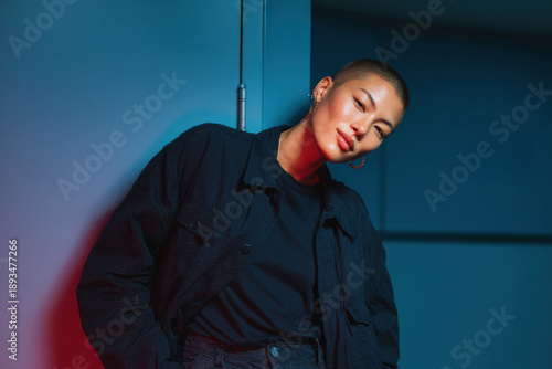 Young woman confidently posing with buzz cut hairstyle